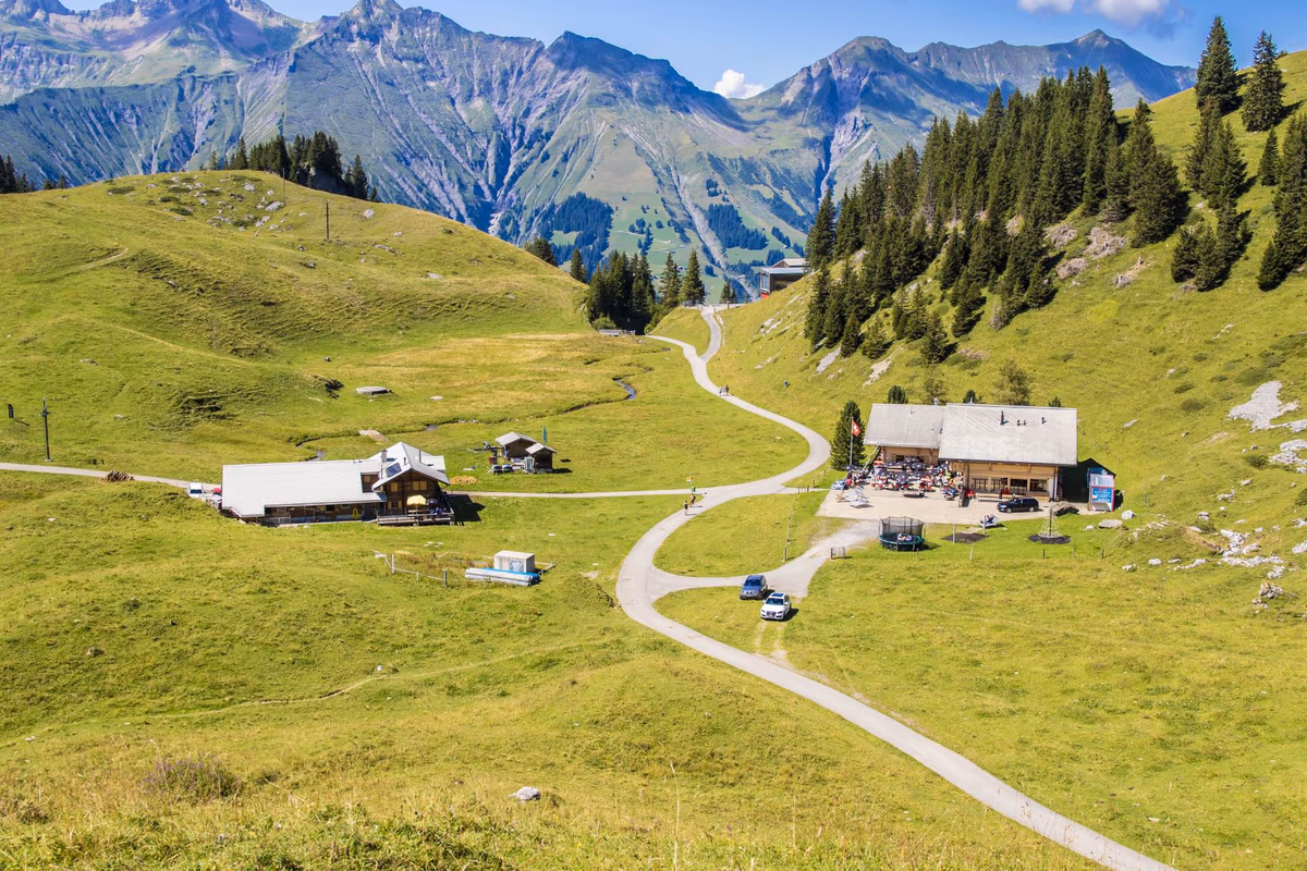 Berghaus Elsigenalp mit Sonnenterrasse in der sommerlichen Berglandschaft